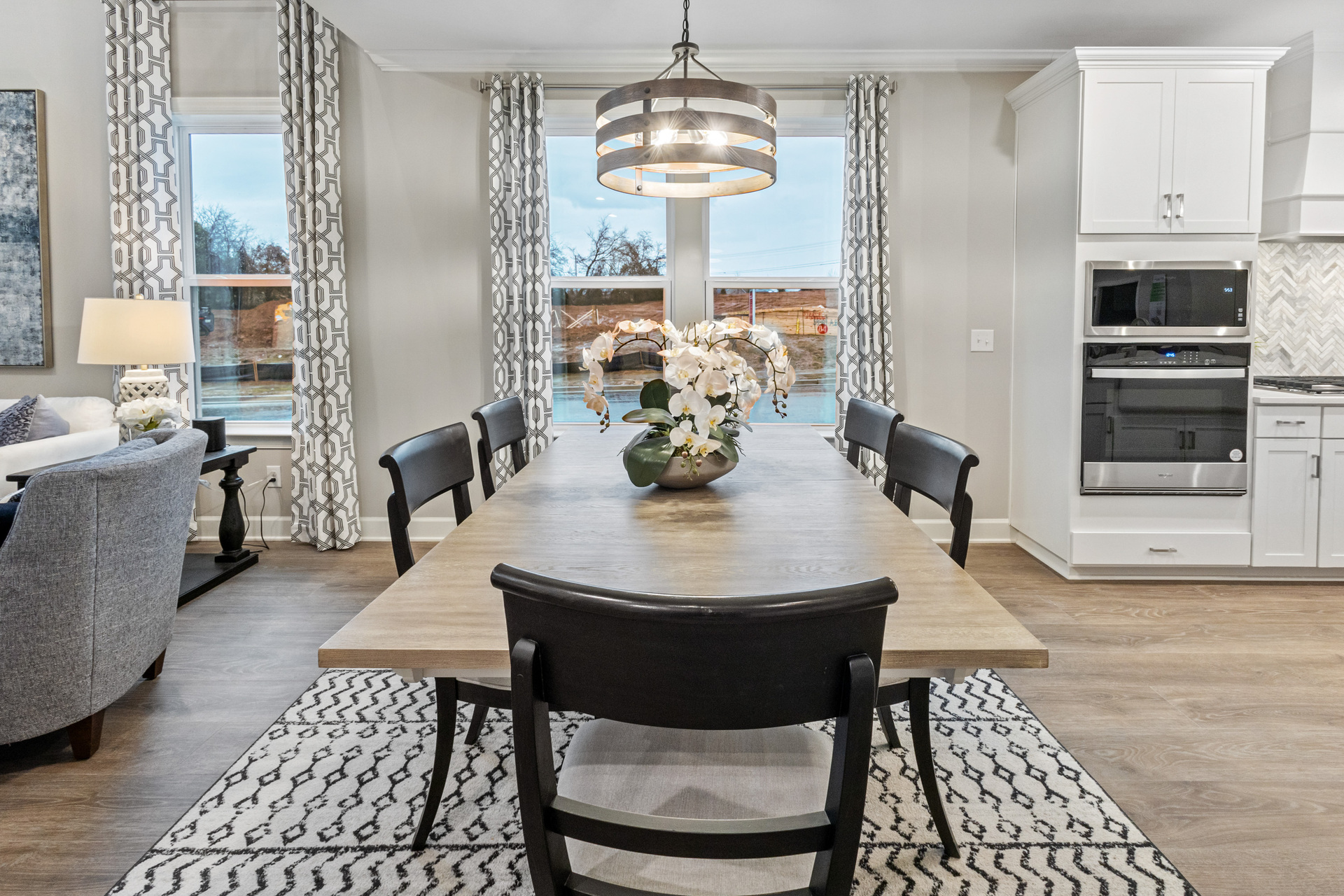 dining room with wood floors, chandelier, and large windows
