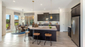 kitchen with black cabinets, white countertops, and a view of the breakfast area
