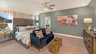 primary bedroom with carpet flooring, white trim, large windows, bed, and dresser