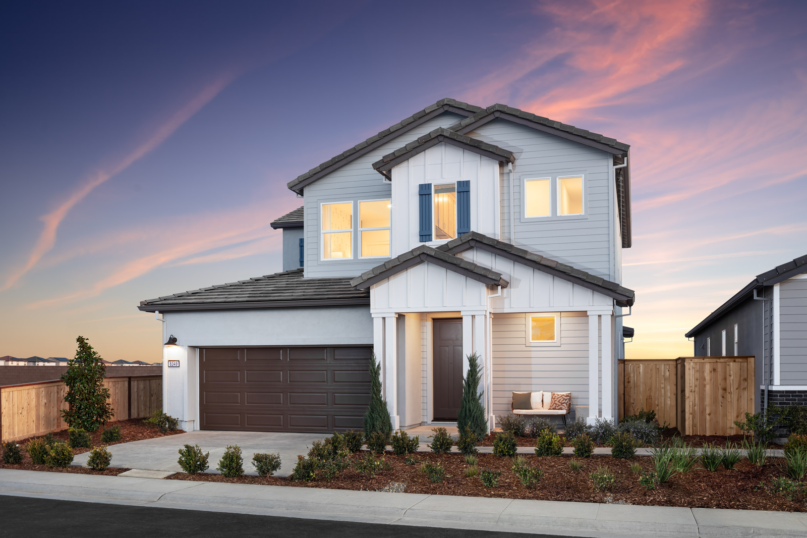 two-story home with brown garage door