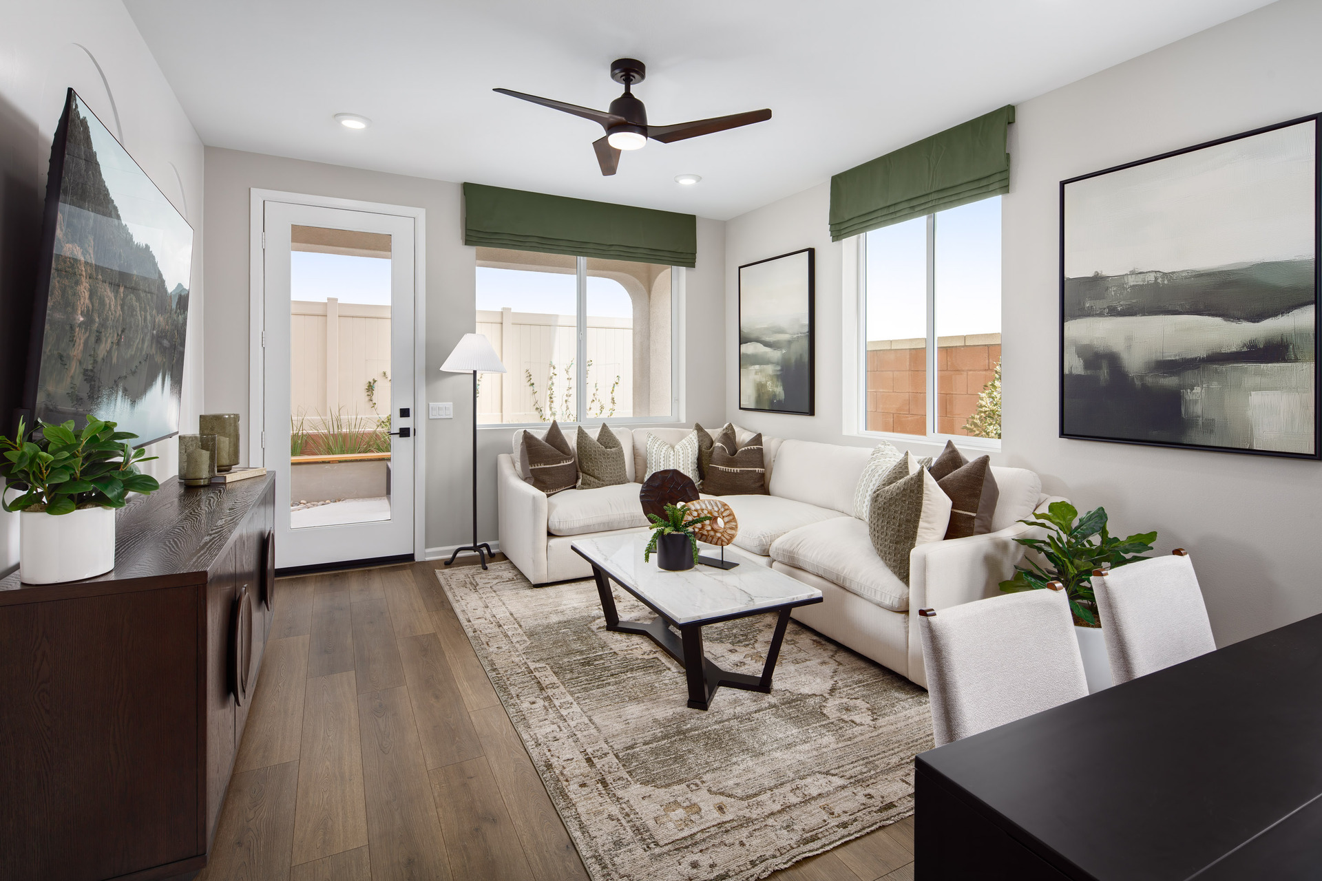 great room with neutral floors and large windows