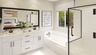 primary bathroom with large window and white countertops