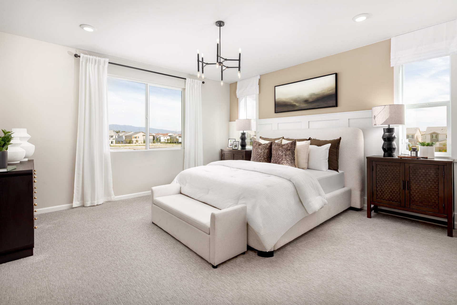 primary bedroom with neutral carpet and large windows