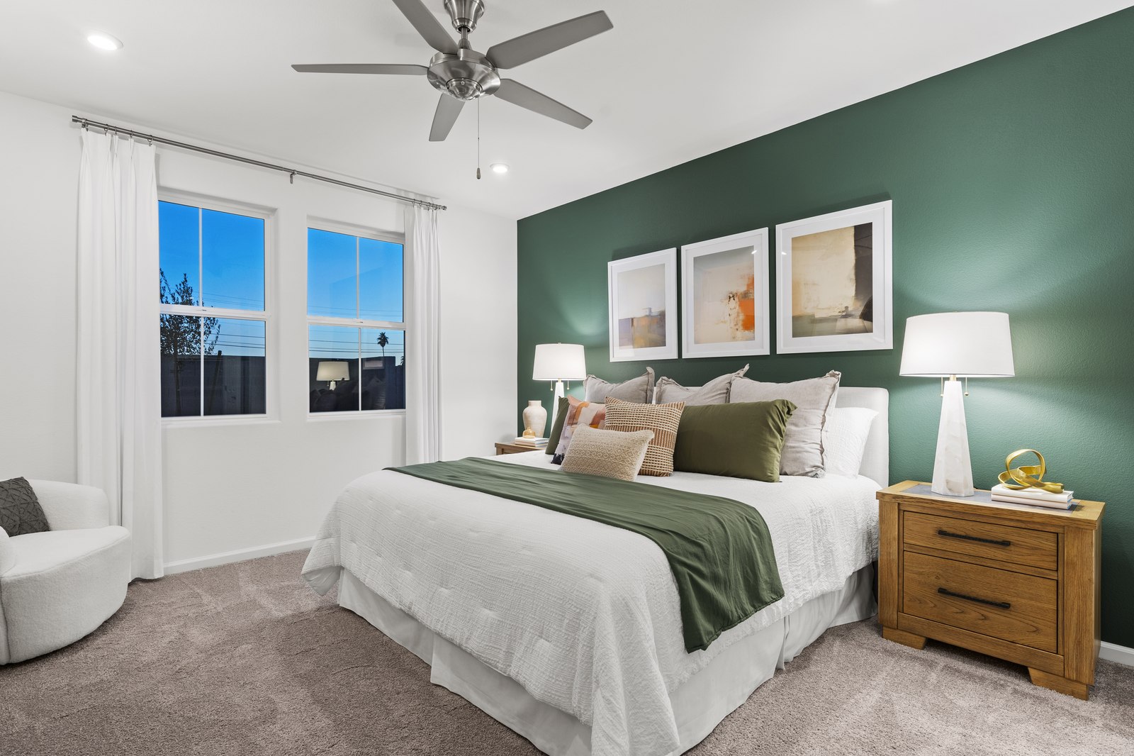 primary bedroom with large bed and accent wall