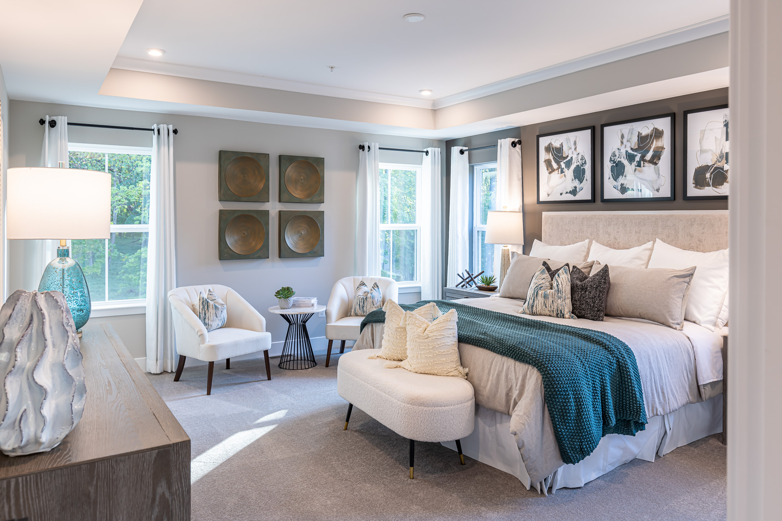 primary suite with a box ceiling and carpet