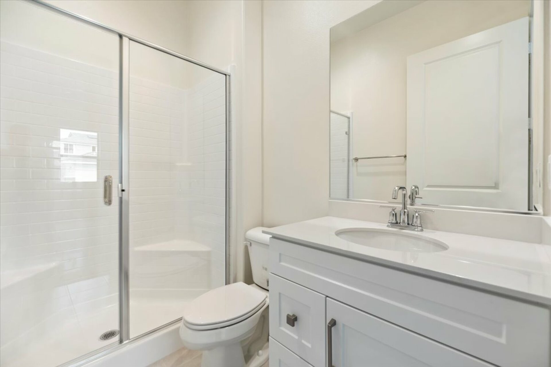 bathroom with large shower and white countertops