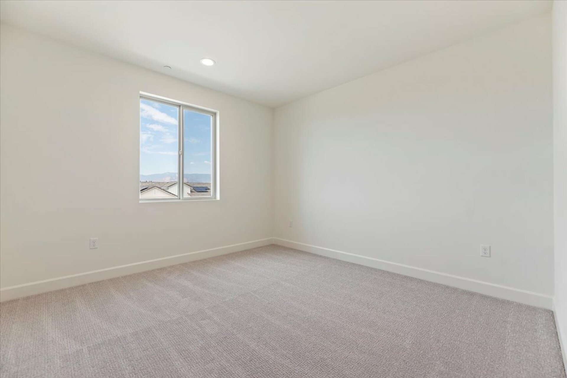 bedroom with neutral carpet and large window