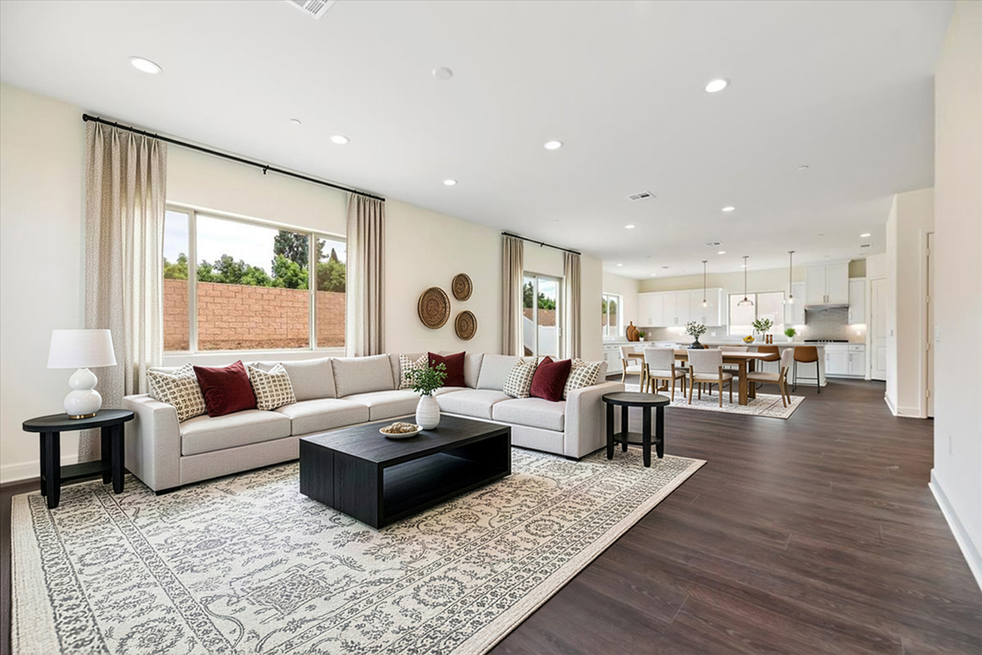 great room with large windows and neutral floors