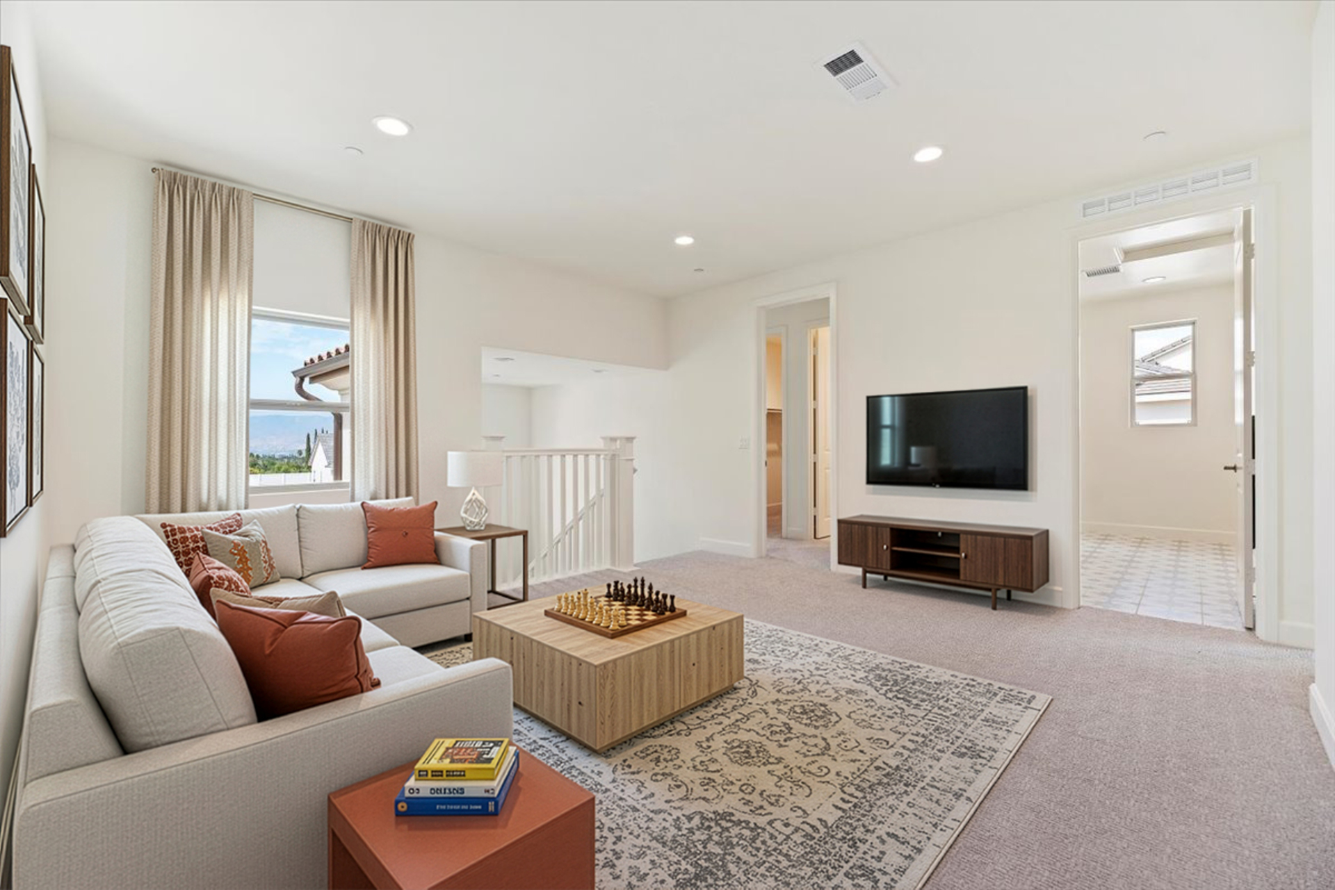 loft with neutral carpet and large windows