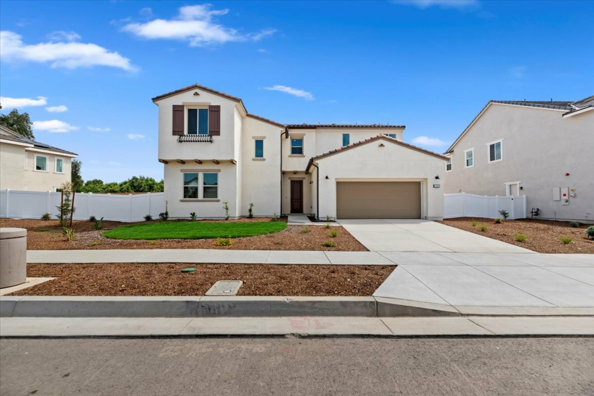 exterior of two story home with front yard landscaping and neutral paint