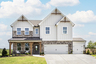 front of 2-story home with 3-car garage featuring white siding and brick