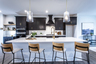 kitchen with dark cabinets and quartz counters