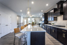 kitchen with dark cabinets and quartz counters